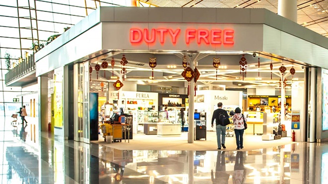 couple entering a duty free shop at the airport